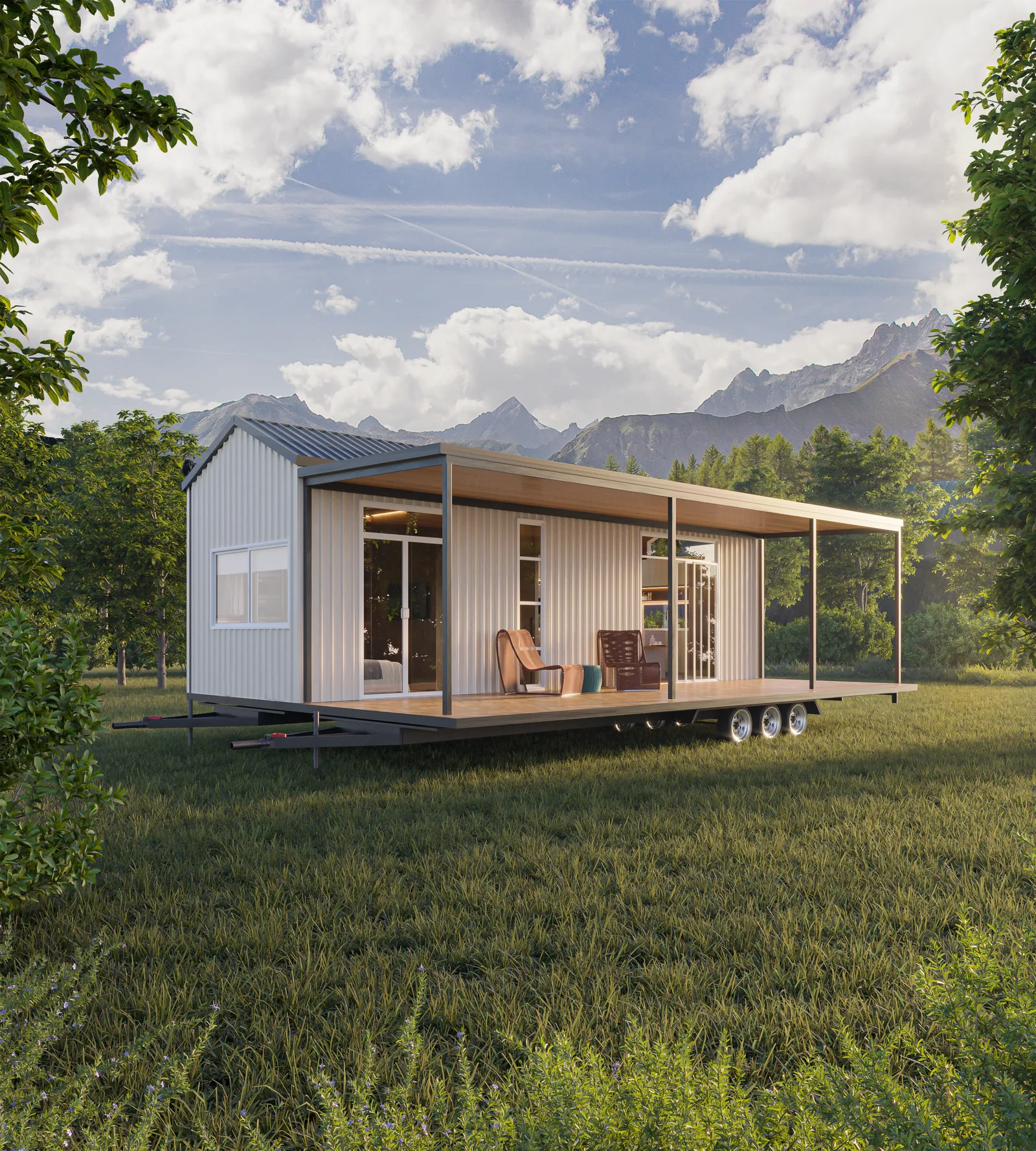 The Ember tiny home on its deck in a meadow, with mountains behind